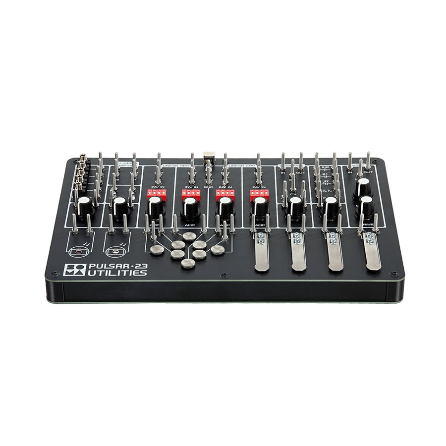 Black electronic device panel with multiple metal pegs, knobs, red switches, levers, and metal discs.