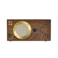 Rectangular wood synthesizer with a gold speaker grille, black rotary knob, and multiple toggle switches on the front panel.