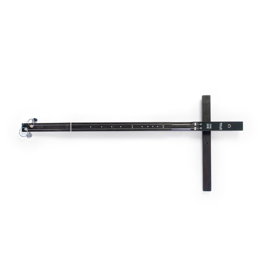 Black stringed musical instrument with tuner knobs and audio jack on a wooden crossbar base.