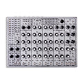 Top view of a modular drum machine with multiple knobs, switches, and 1/4 inch jacks on a silver metal panel.