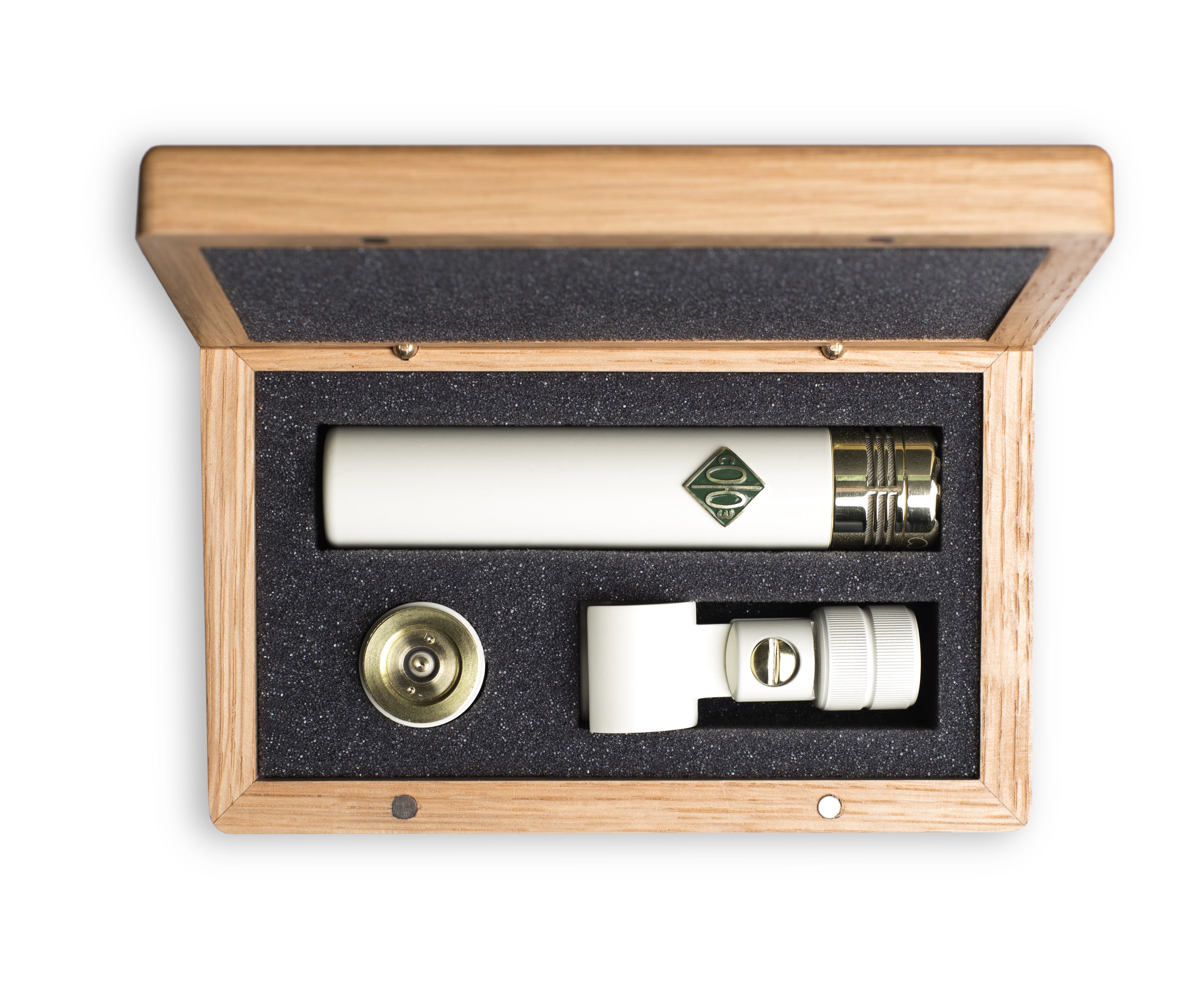 White cylindrical microphone with gold connector and accessories in a wooden box with foam insert.