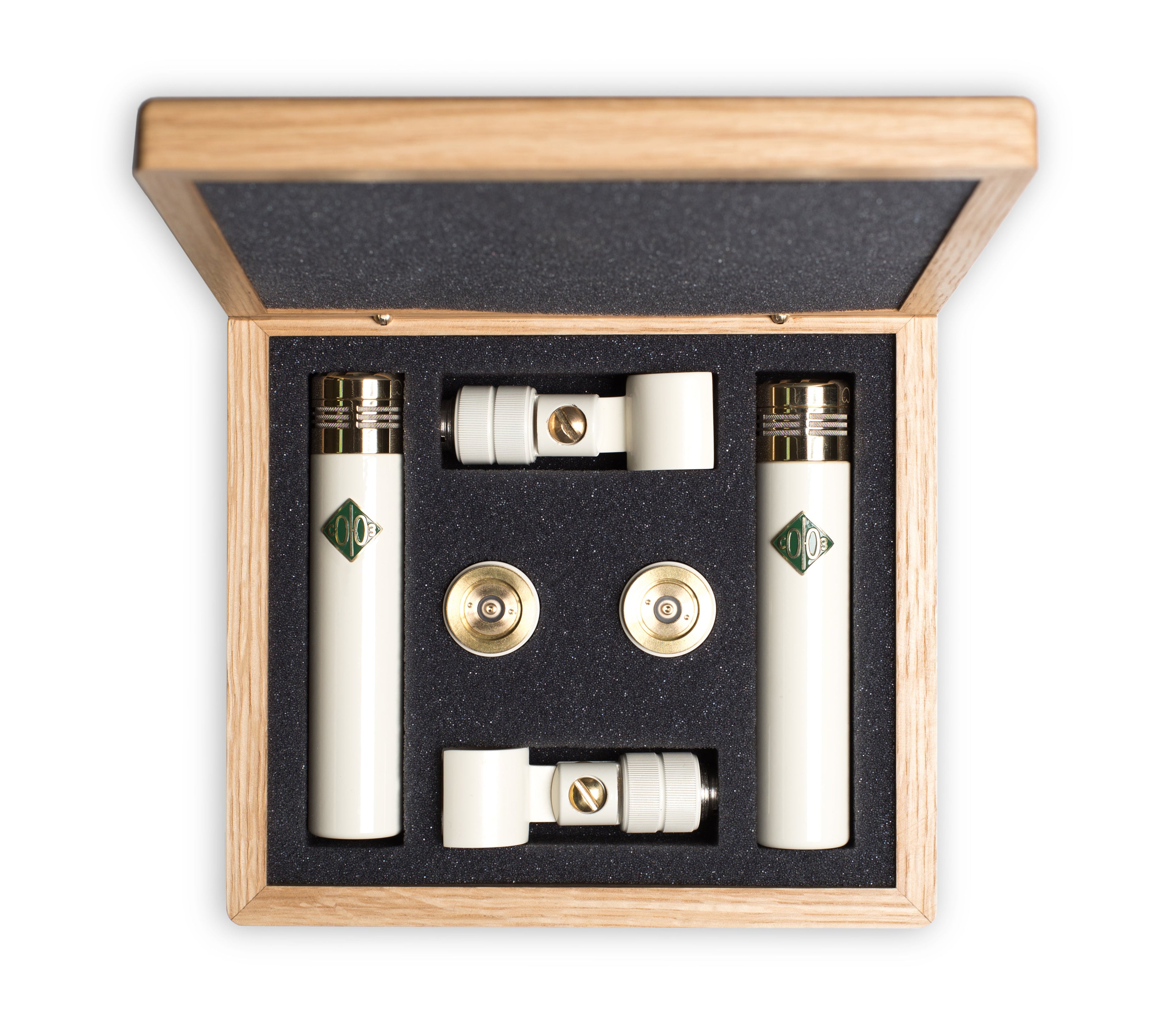 Two white cylindrical microphones and accessories in a wooden box with black foam insert.