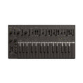 Black synthesizer with piano keys and various knobs, sliders, and buttons on top panel