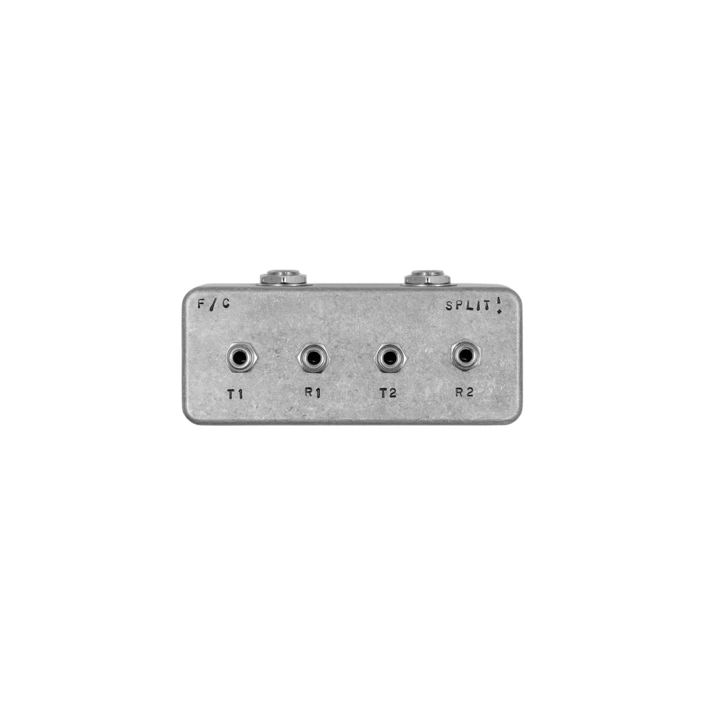 Small metal audio splitter box with four 1/4 inch jack sockets labeled T1, R1, T2, R2 and text F / C and SPLIT!
