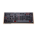 Black desktop synthesizer with multiple knobs, buttons, and red digital displays on a white background.