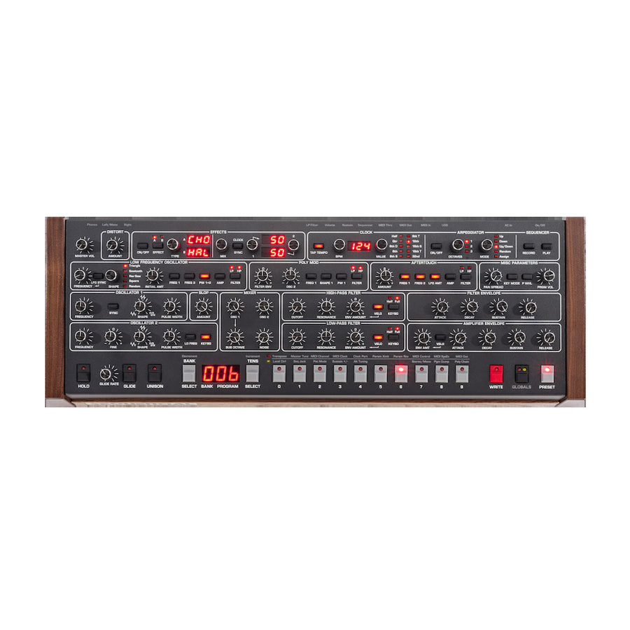 Top view of a synthesizer control panel with multiple knobs, buttons, and digital displays, featuring wood side panels.