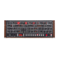 Top view of a synthesizer control panel with multiple knobs, buttons, and digital displays, featuring wood side panels.