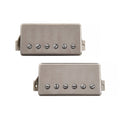 Two silver humbucker guitar pickups with six adjustable screws and braided wire leads.