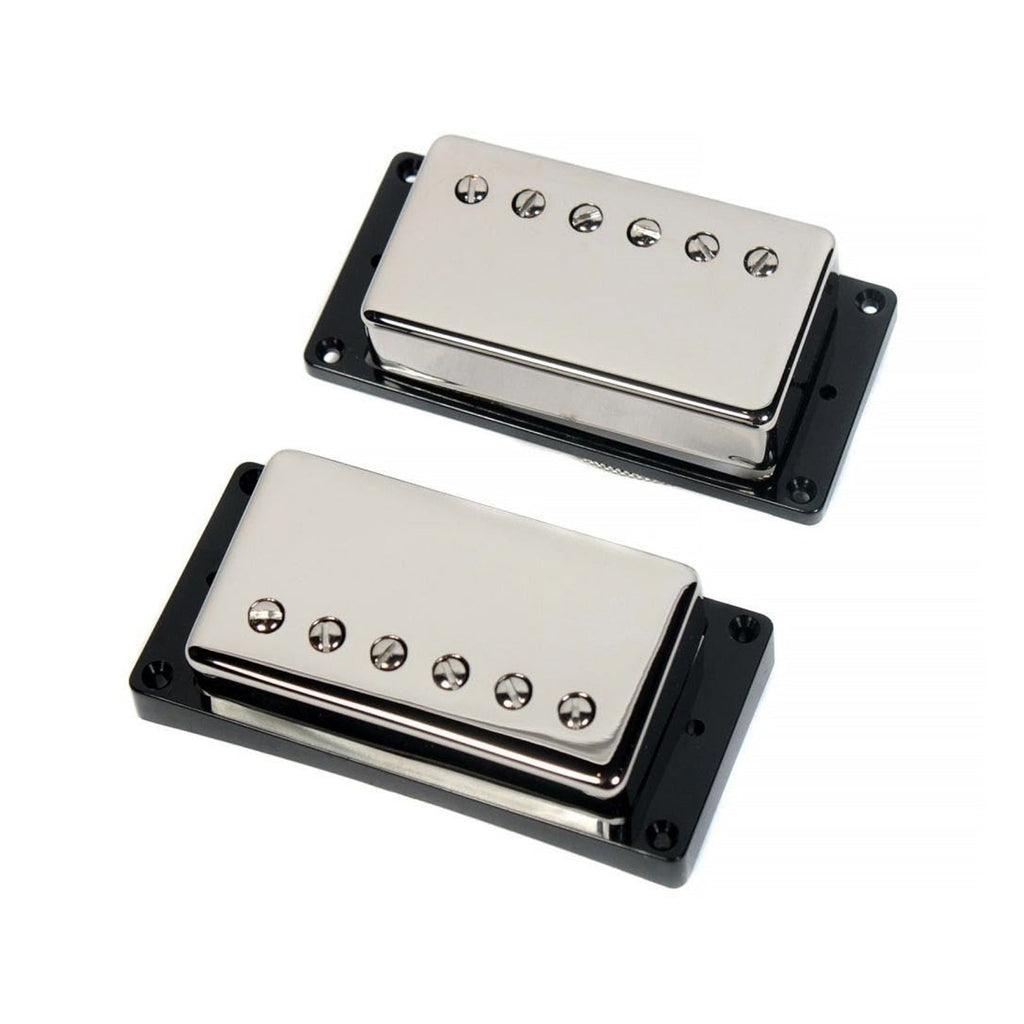 Two silver humbucker guitar pickups with black mounting frames and adjustment screws.