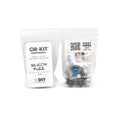 Two clear plastic bags contain labeled DIY electronic components including capacitors, potentiometers, a jack socket, and a switch.