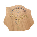 Wooden synthesizer panel with multiple silver and gold knobs and various symbols printed on it.