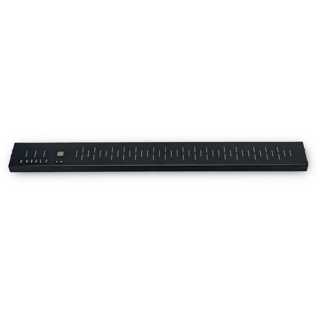 Long black synthesizer control surface with sliders, buttons labeled V, C, A, R, S, T, P, and several 3.5mm jacks on the left side.