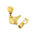 Gold-colored guitar tuning peg with bushing, washer, and screw on white background.