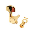 Gold-colored guitar tuning peg with mounting screw, washer, and bushing on a white background.
