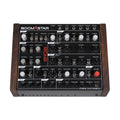 Top view of a black Studio Electronics Boomstar 8106 MkII synthesizer with wooden side panels and various knobs and jacks.