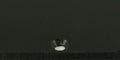 Close-up of a black matte surface with a single recessed hole.