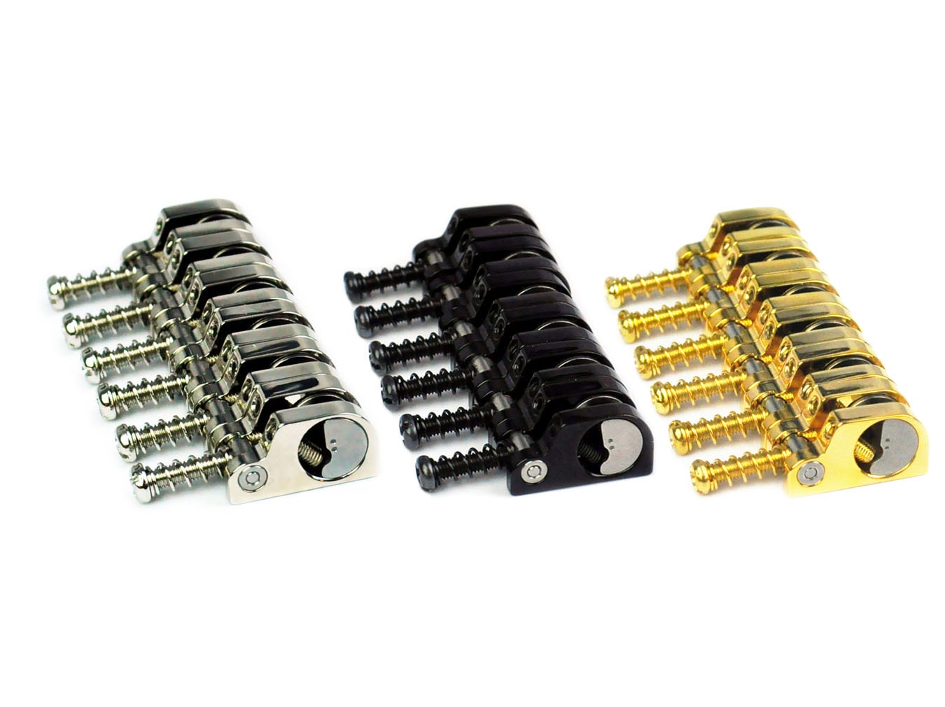 Three sets of metal guitar saddles with screws in silver, black, and gold finishes.