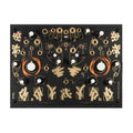 Black analog synthesizer module with orange and gold graphics, multiple knobs, switches, and jack connectors on its front panel.