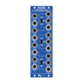 Blue electronic module with multiple 1/8 inch jacks, toggle switches, and white labels showing inputs and outputs.