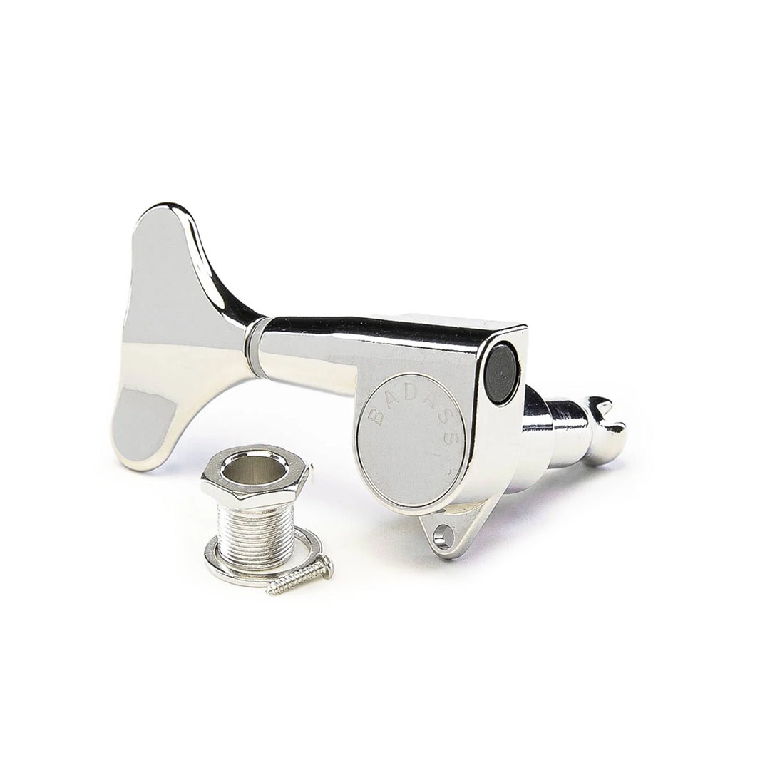 A silver metal tuning peg key with mounting bushing and screw, with the word BADASS engraved on it.