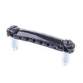 Black metal tailpiece with two screws and six string holes, set against a white background.
