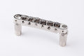 Silver metallic roller tune-o-matic guitar bridge with screw adjustment knobs on a white background.