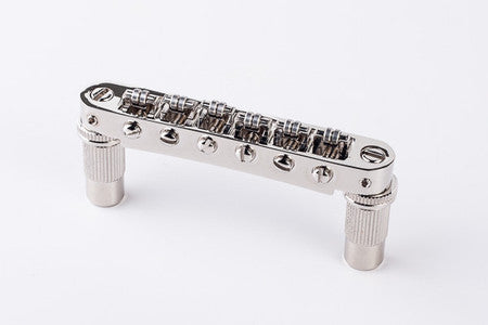 Silver metallic roller tune-o-matic guitar bridge with screw adjustment knobs on a white background.