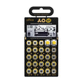 Black and yellow Teenage Engineering Pocket Operator Office sampler in packaging with multiple buttons and small screen.