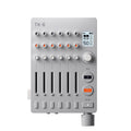 Top view of a gray mixing device with knobs, sliders, buttons, a small display, and a rotary dial on a white background.