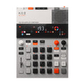 Top view of a K.O. II 128 MB sampler composer showing its display, buttons, knobs, fader, and connectors.