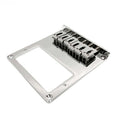 Chrome metal guitar bridge plate with six adjustable saddles photographed on white background