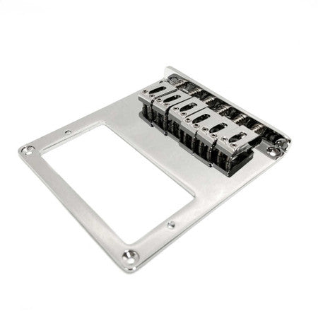Chrome metal guitar bridge plate with six adjustable saddles photographed on white background