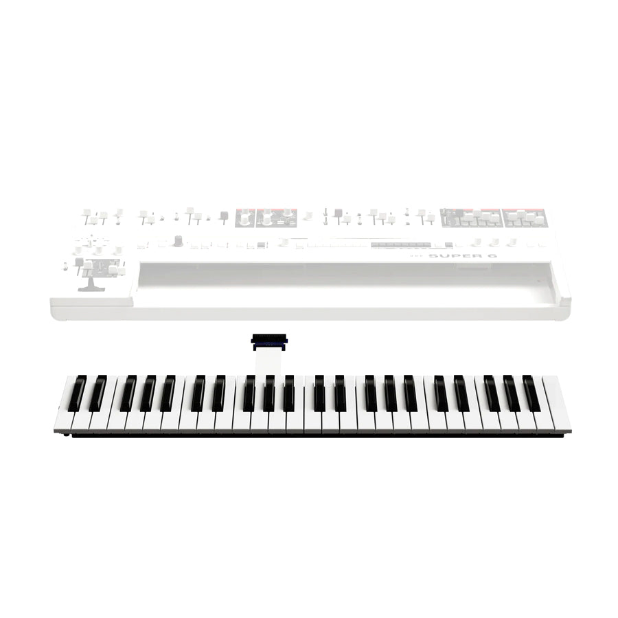 A white and black 49-key keyboard module with a flat ribbon connector, shown in front of a transparent Super 6 synthesizer body.