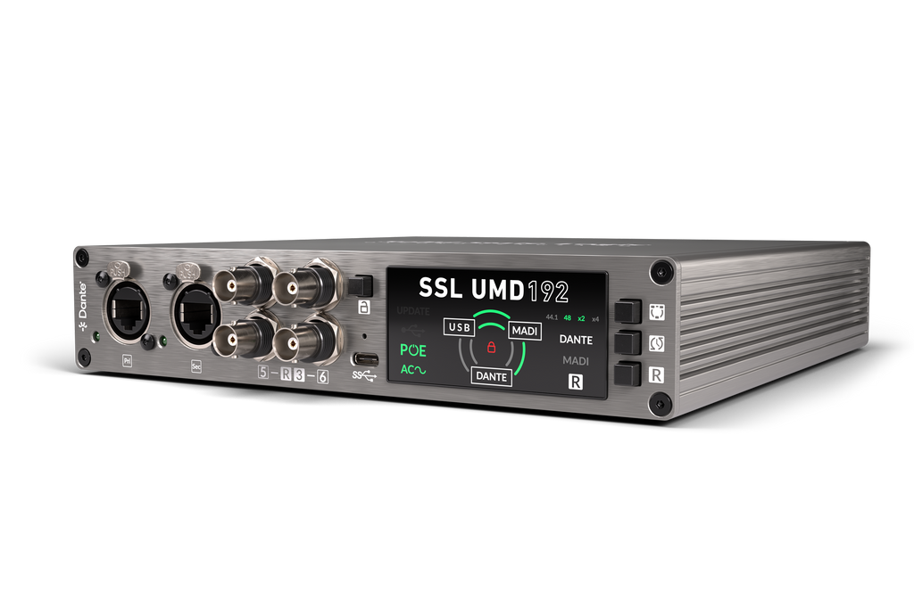 Front angle view of a Silver and black audio interface unit with RJ45, BNC, USB-C ports and a digital display.