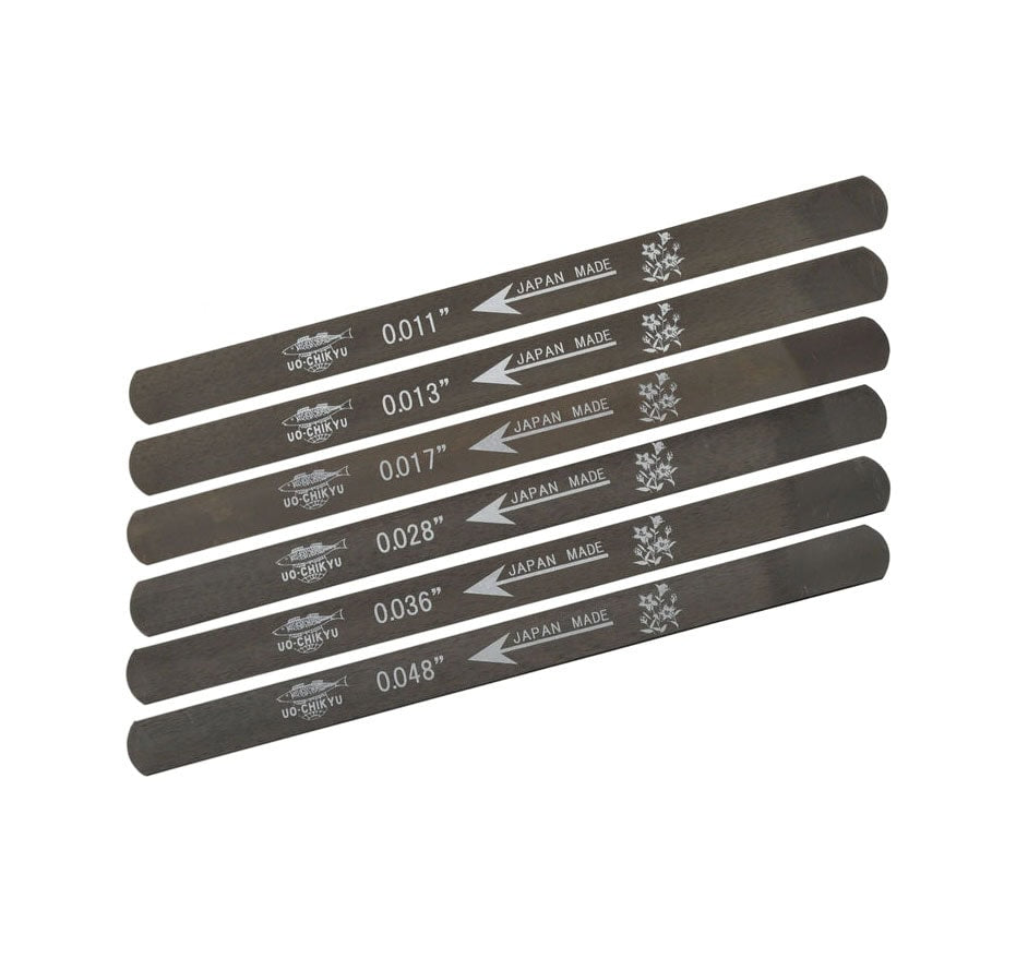 Six thin metal files marked with measurements from 0.011 to 0.048 inches, labeled UO-CHIKYU and Japan Made.