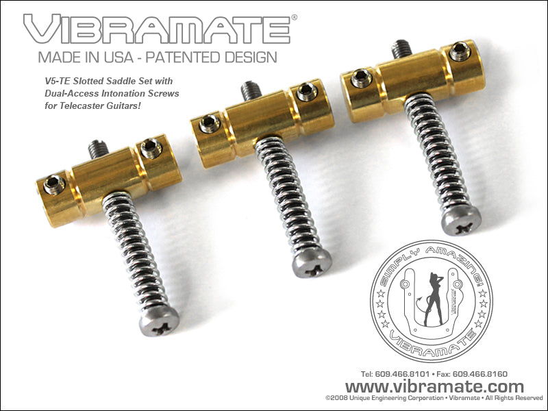 Three brass guitar saddles each with a silver dual-access intonation screw and black adjustment screw.