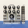 Two modular audio mixer and I/O expander modules with knobs, LED meters, and multiple jacks on a blue surface.