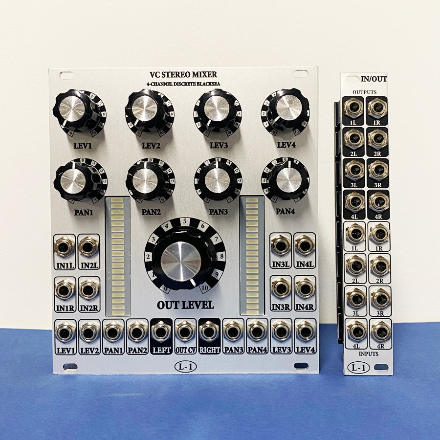 Two modular audio mixer and I/O expander modules with knobs, LED meters, and multiple jacks on a blue surface.
