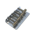 A metal bass bridge component with four saddles and adjustment screws on a rectangular base plate.