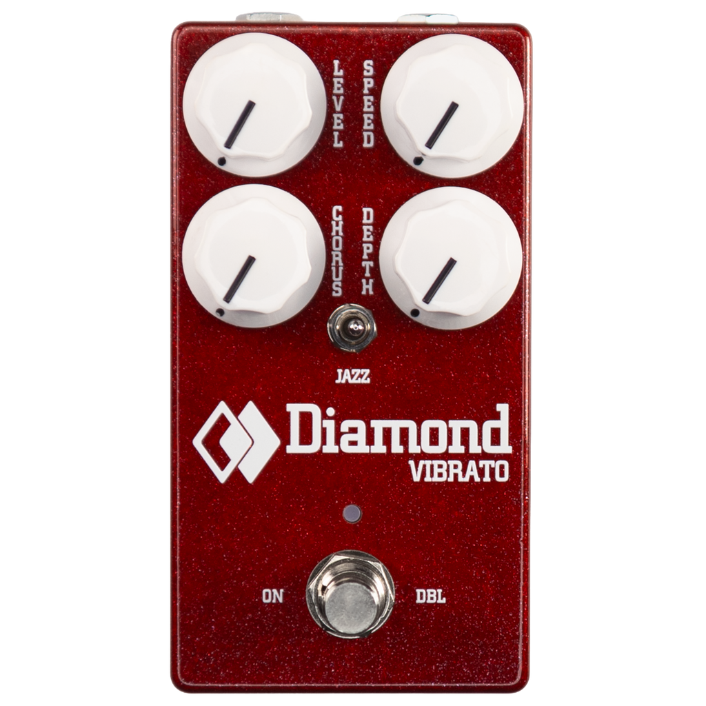 Red guitar effect pedal with four white knobs, a toggle switch, and a footswitch labeled Diamond Vibrato.