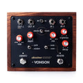 Top view of a wood-framed guitar effects pedal with knobs, toggle switches, and input/output jacks.