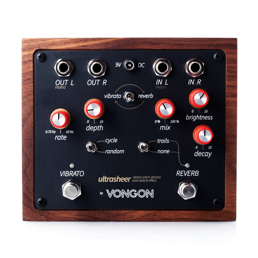 Top view of a wood-framed guitar effects pedal with knobs, toggle switches, and input/output jacks.