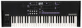 Top-down view of a black 61-key Korg wavestate wave sequencing synthesizer with lit buttons and control knobs.