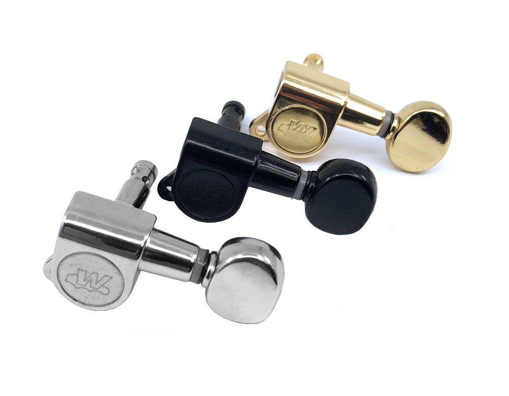 Three individual guitar machine head tuners in silver, black, and gold with a W logo on each.