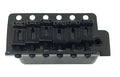 Black metal guitar bridge with six adjustable saddles and screws, labeled Wilkinson.