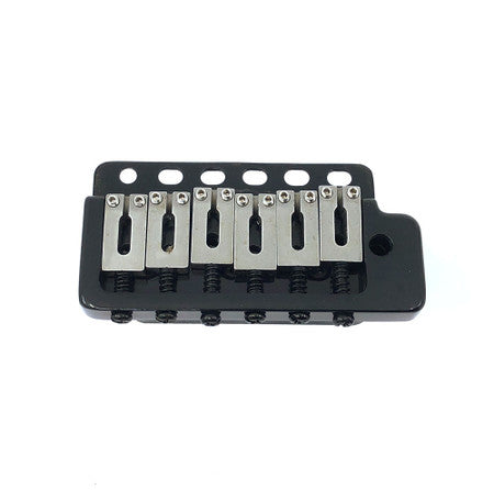 Black guitar tremolo bridge with six metal saddles and six mounting holes.