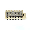 Gold-colored 6-saddle guitar tremolo bridge with six mounting holes on a white background.