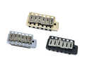 Three metal guitar bridges in silver, gold, and black finishes for string adjustment.