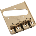 Gold metal guitar bridge plate with three brass saddles and screws, labeled Wilkinson by Schaller.