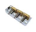 Metal guitar bridge with gold saddles and springs on a silver base plate